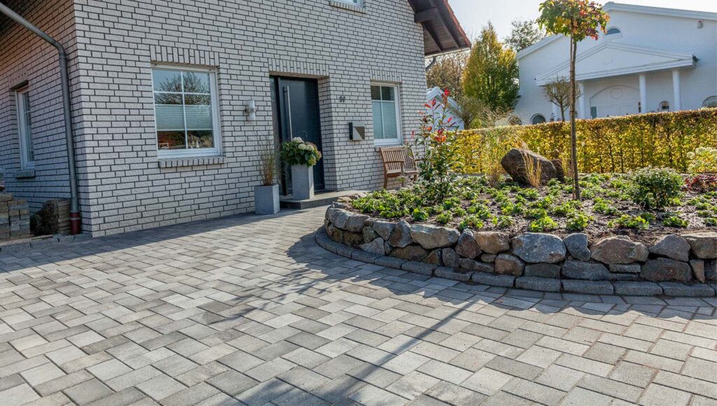 Wasserdurchl&auml;ssige Pflastersteine vor einem Haus 